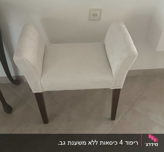 שרפרף מרופד עם רגלי עץ על רצפת אריחים